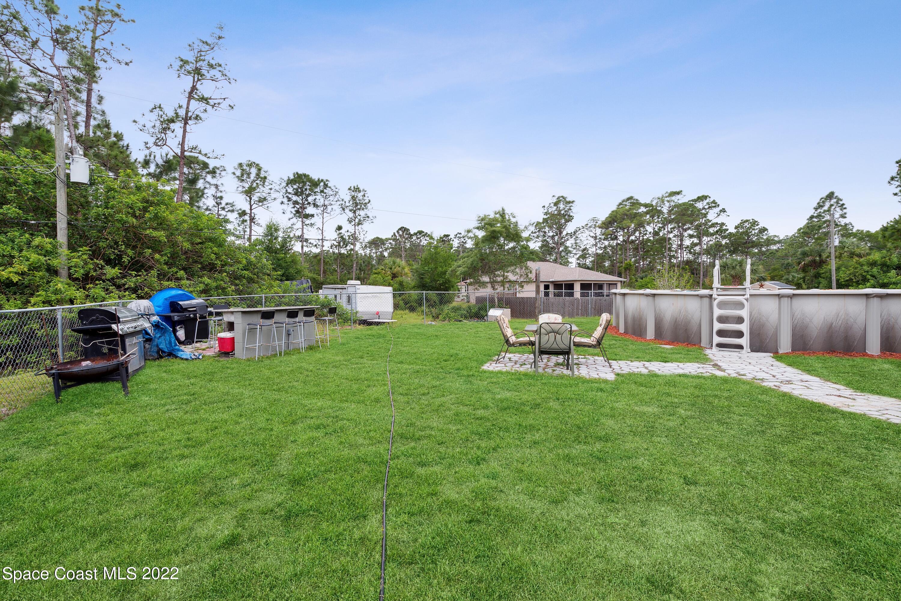 816 Tedder Road Southeast Palm Bay, FL 32909 - Photo 15 of 18 15_816TedderRd_26003_BackYard_HiRes