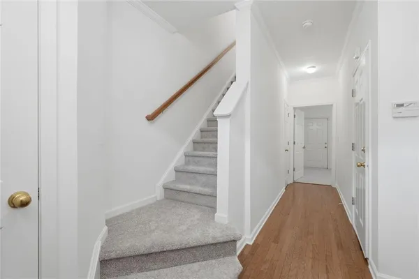 a view of a hallway with sliding door and stairs