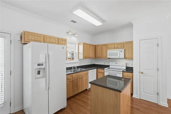a kitchen with stainless steel appliances a refrigerator sink and cabinets