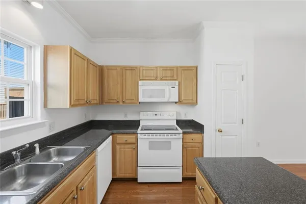 a kitchen with a sink stove and cabinets