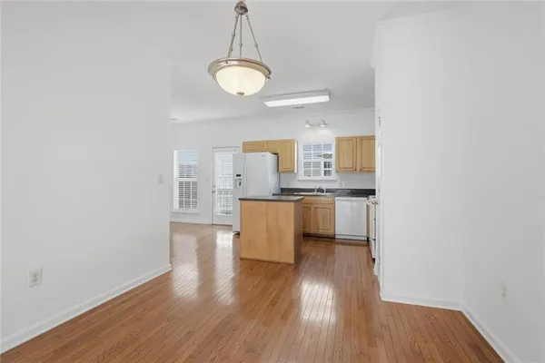 a kitchen with stainless steel appliances granite countertop a sink a stove a refrigerator and microwave