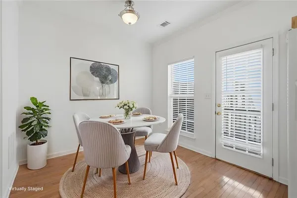 a view of a dining room with furniture window and wooden floor