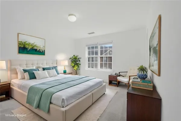 a bedroom with a bed and a couch