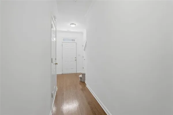 a view of hallway with wooden floor