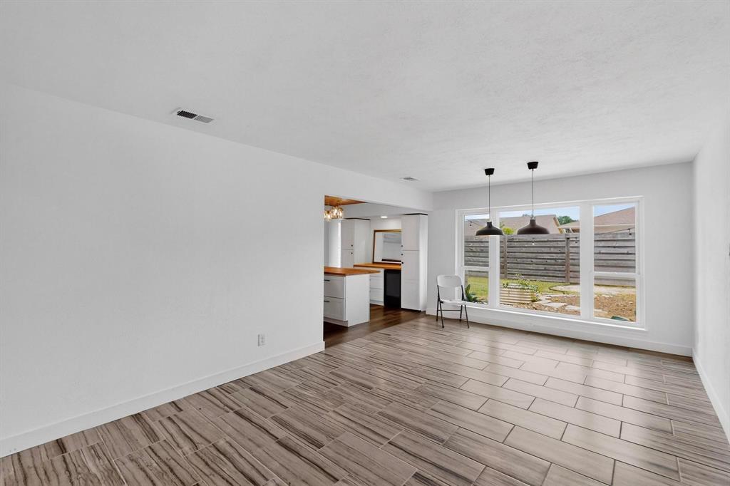 4857 Fallon Place Dallas, TX 75227 - Photo 8 of 19 Unfurnished living room with wood finish floors and baseboards