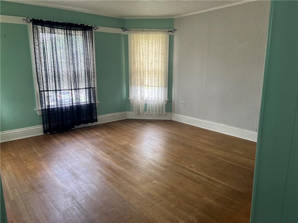 802 4th Street Rochester, PA 15074 - Photo 15 of 31 an empty room with wooden floor and windows