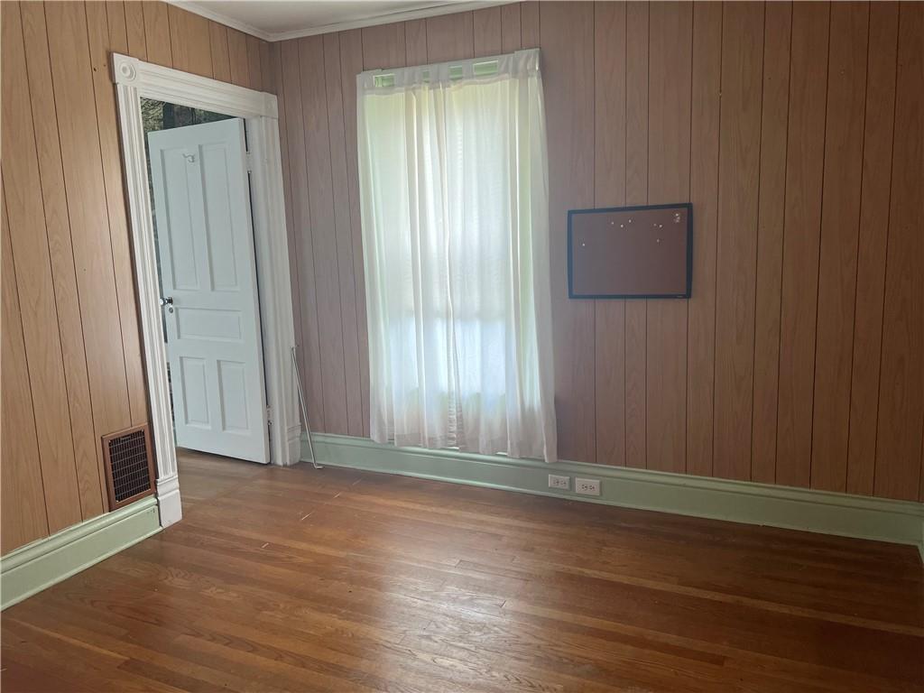 802 4th Street Rochester, PA 15074 - Photo 17 of 31 an empty room with wooden floor and windows