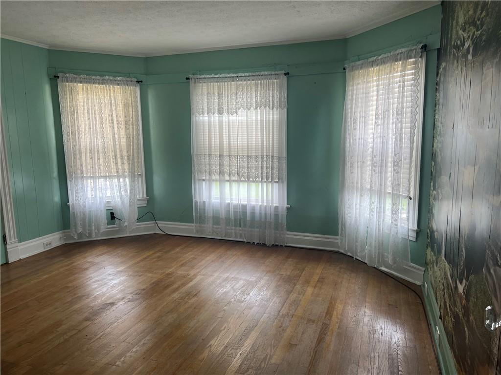 802 4th Street Rochester, PA 15074 - Photo 18 of 31 an empty room with wooden floor and windows