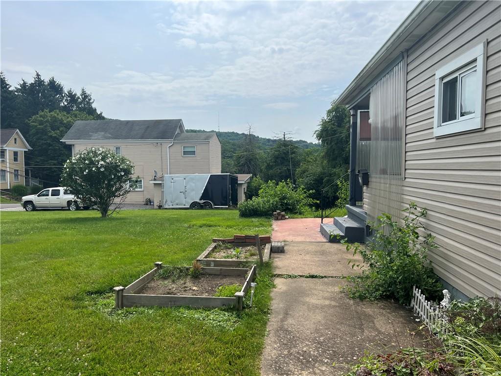 802 4th Street Rochester, PA 15074 - Photo 27 of 31 a view of a house with a yard and sitting area