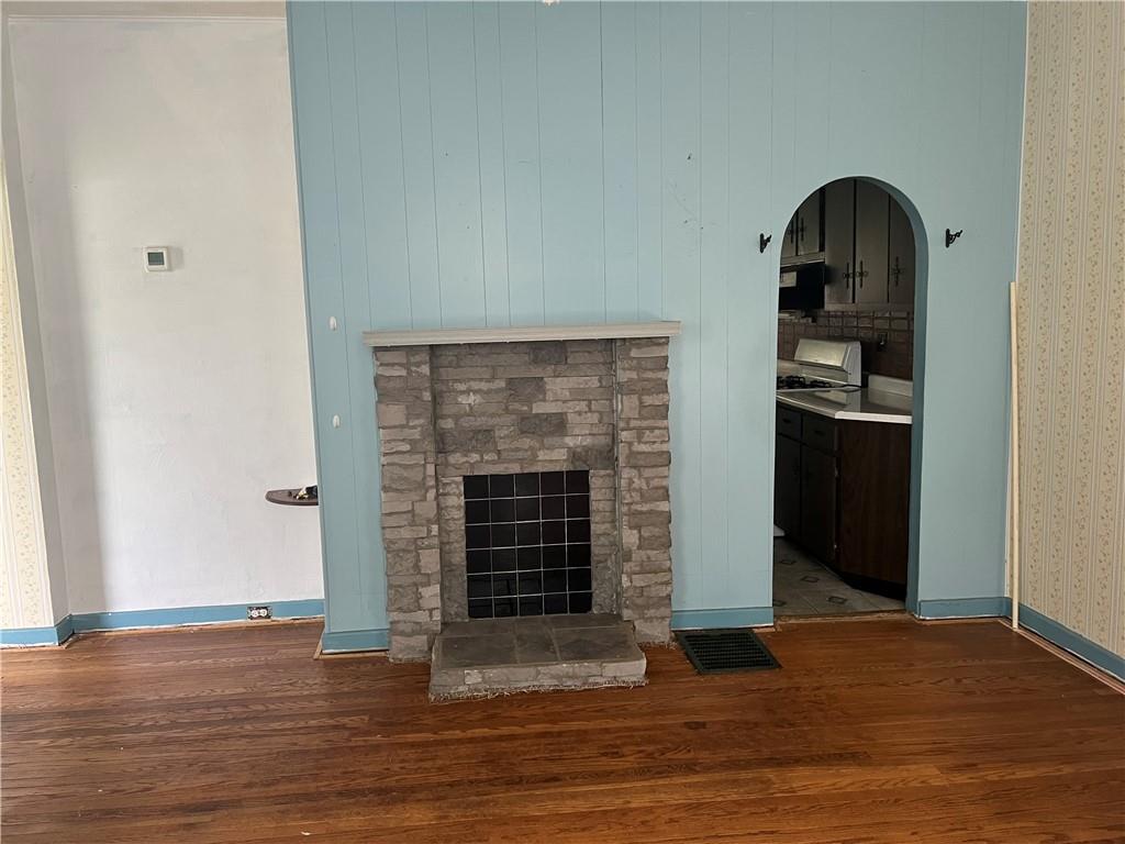802 4th Street Rochester, PA 15074 - Photo 7 of 31 a view of an empty room with wooden floor and a fireplace