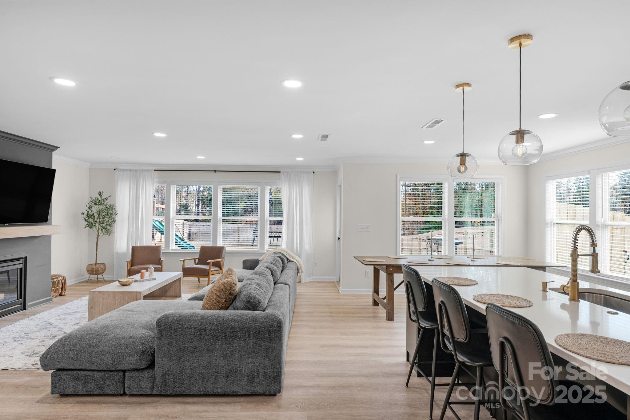 12847 Connemara Court Midland, NC 28107 - Photo 11 of 47 a living room with furniture a flat screen tv and a large window