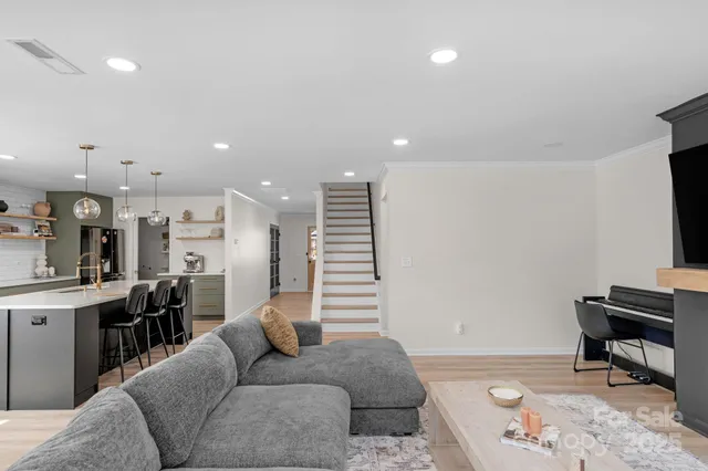 a living room with furniture and a piano
