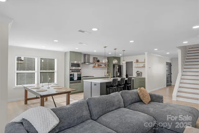 a living room with furniture and a kitchen