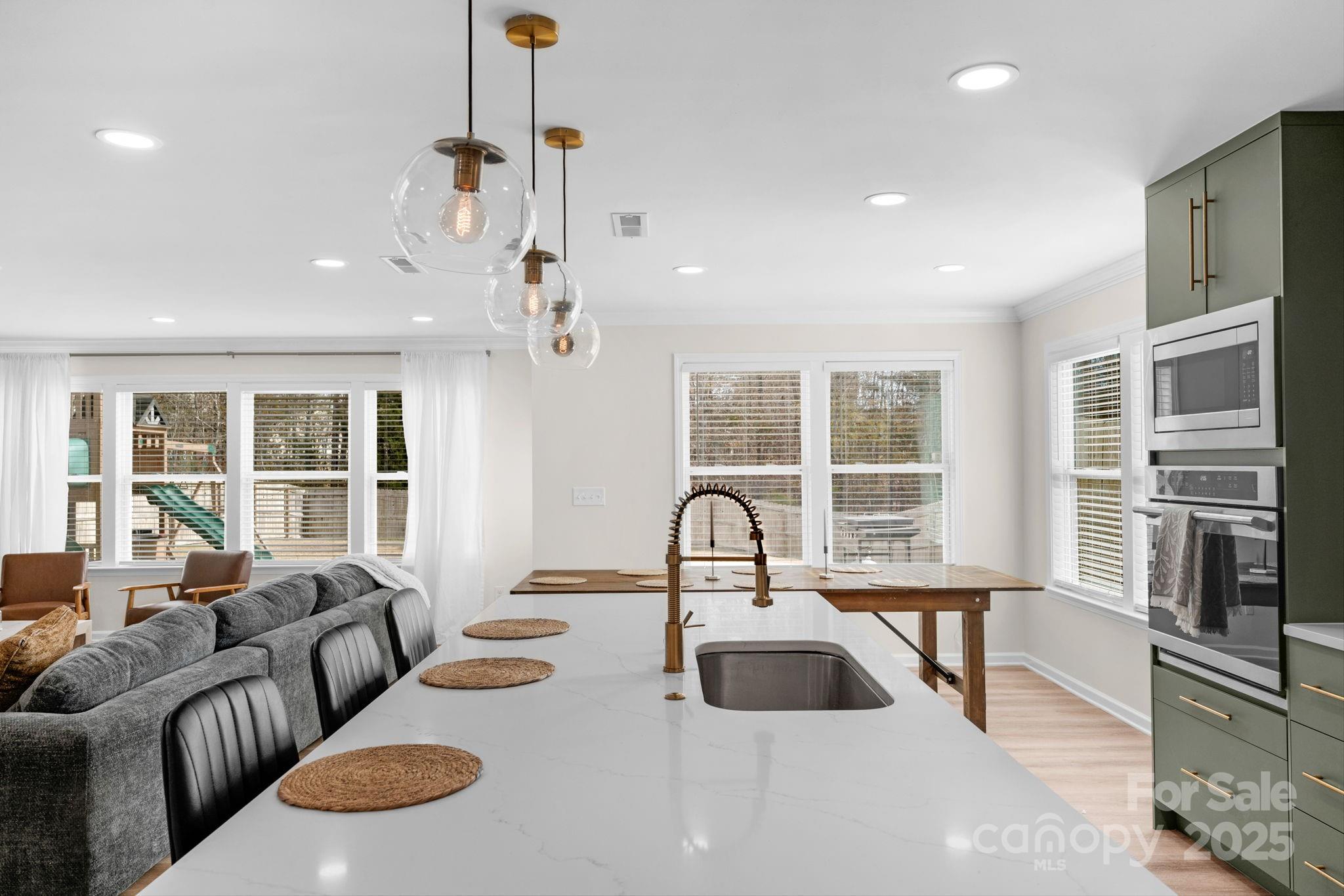 12847 Connemara Court Midland, NC 28107 - Photo 19 of 47 a living room with furniture a large window and a chandelier
