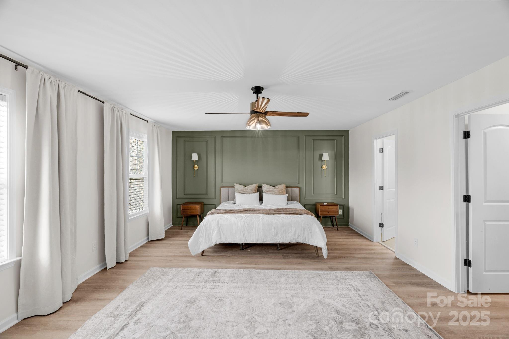 12847 Connemara Court Midland, NC 28107 - Photo 26 of 47 a bedroom with a large bed and a chandelier