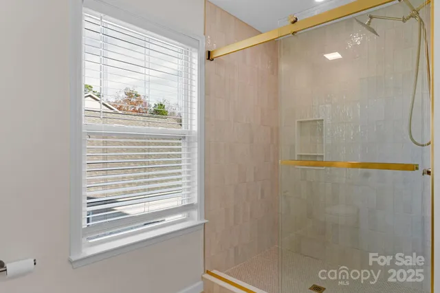 a bathroom with a window and a shower