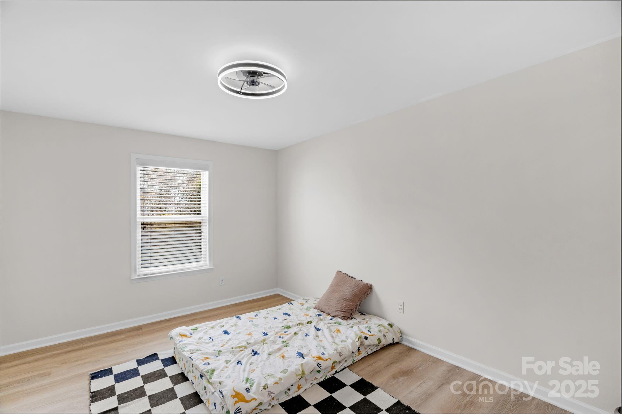 12847 Connemara Court Midland, NC 28107 - Photo 31 of 47 a bedroom with a bed and wooden floor