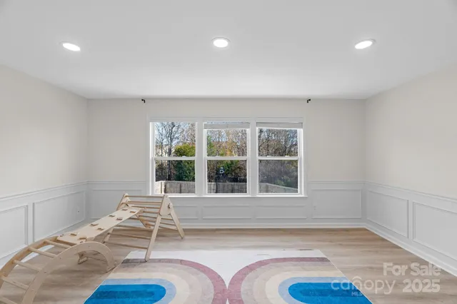 a living room with a bed furniture and a window