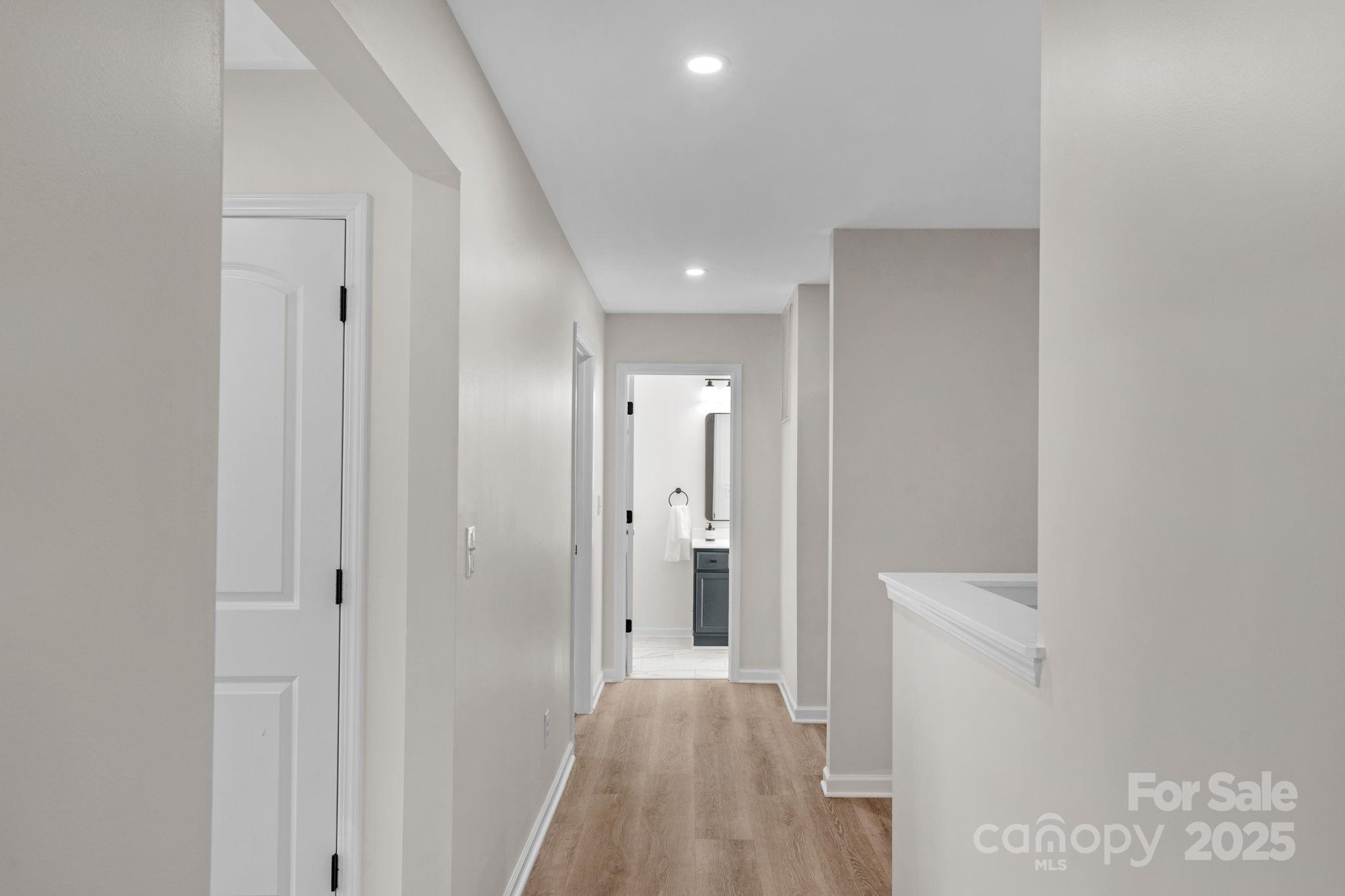 12847 Connemara Court Midland, NC 28107 - Photo 36 of 47 a view of a hallway with wooden floor and a bathroom