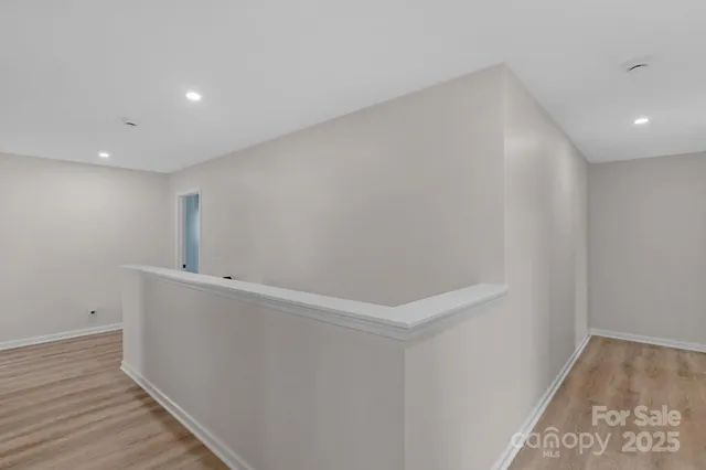 a view of hallway with wooden floor