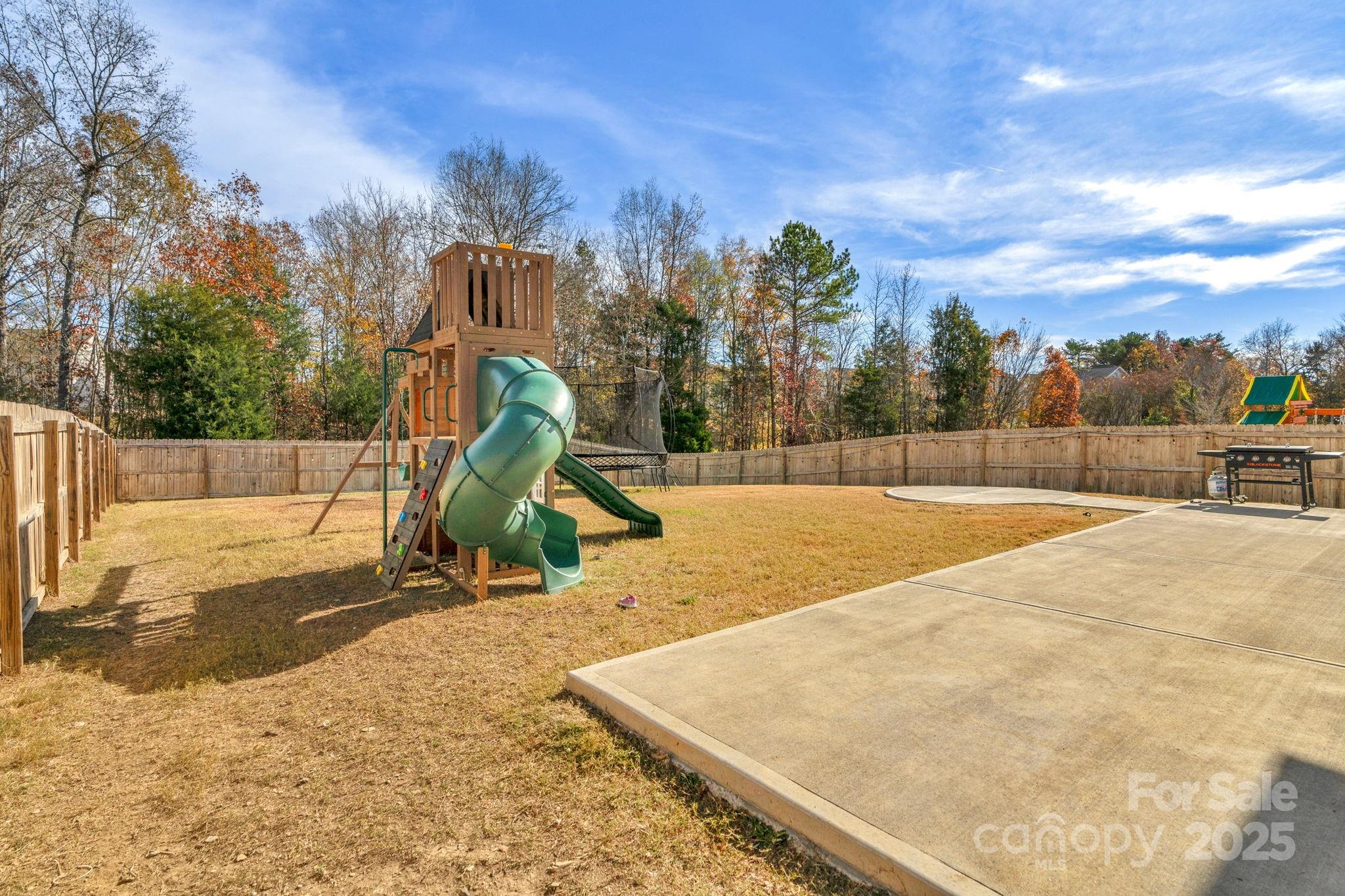 12847 Connemara Court Midland, NC 28107 - Photo 40 of 47 a view of outdoor space with swimming pool and trees