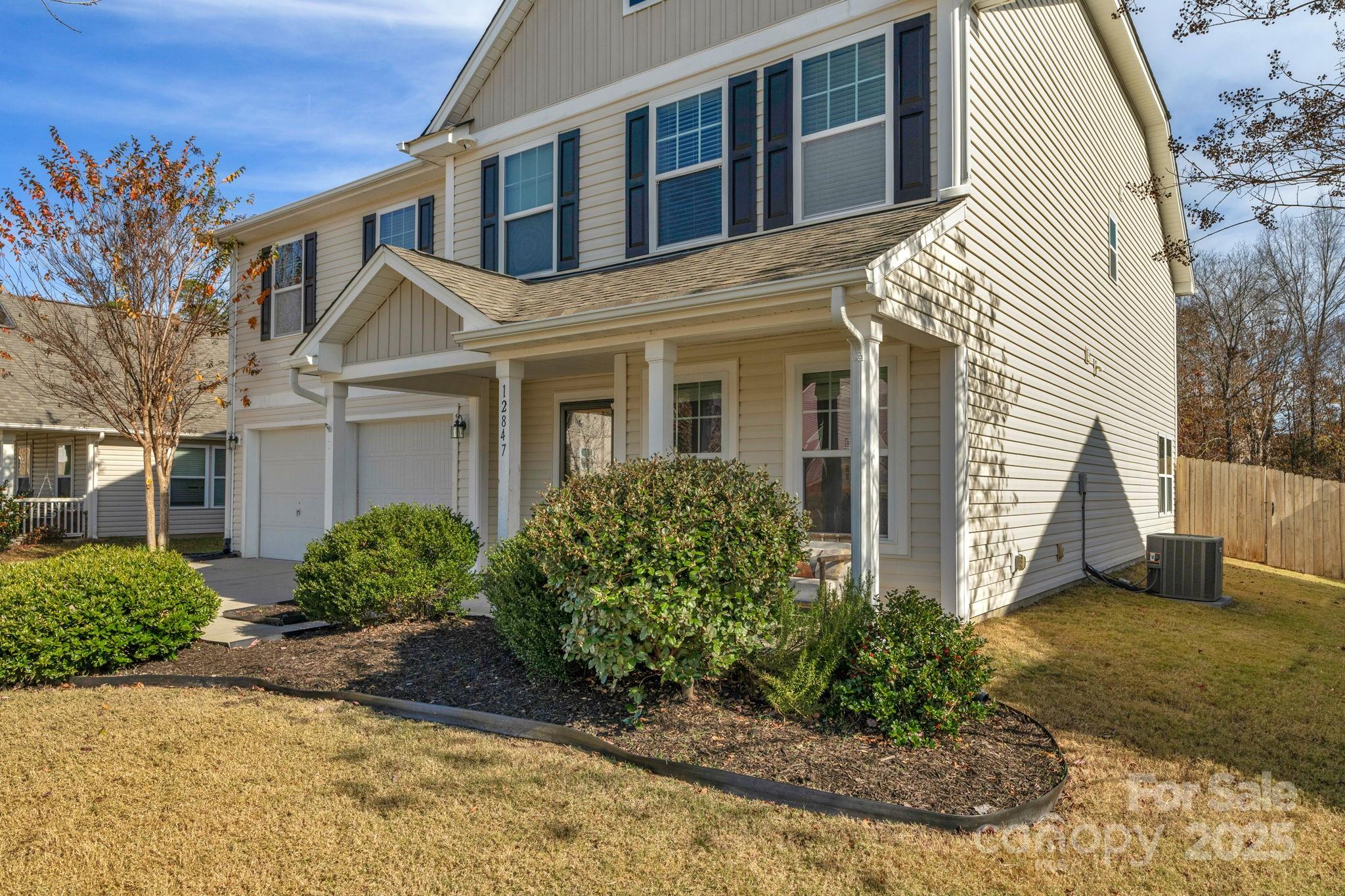 12847 Connemara Court Midland, NC 28107 - Photo 4 of 47 a front view of a house with garden