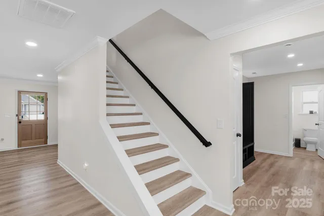 a view of a hallway with wooden floor and entryway