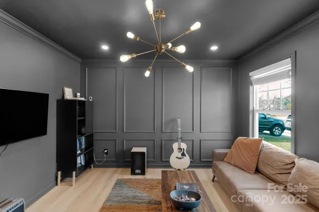 a living room with furniture and a flat screen tv