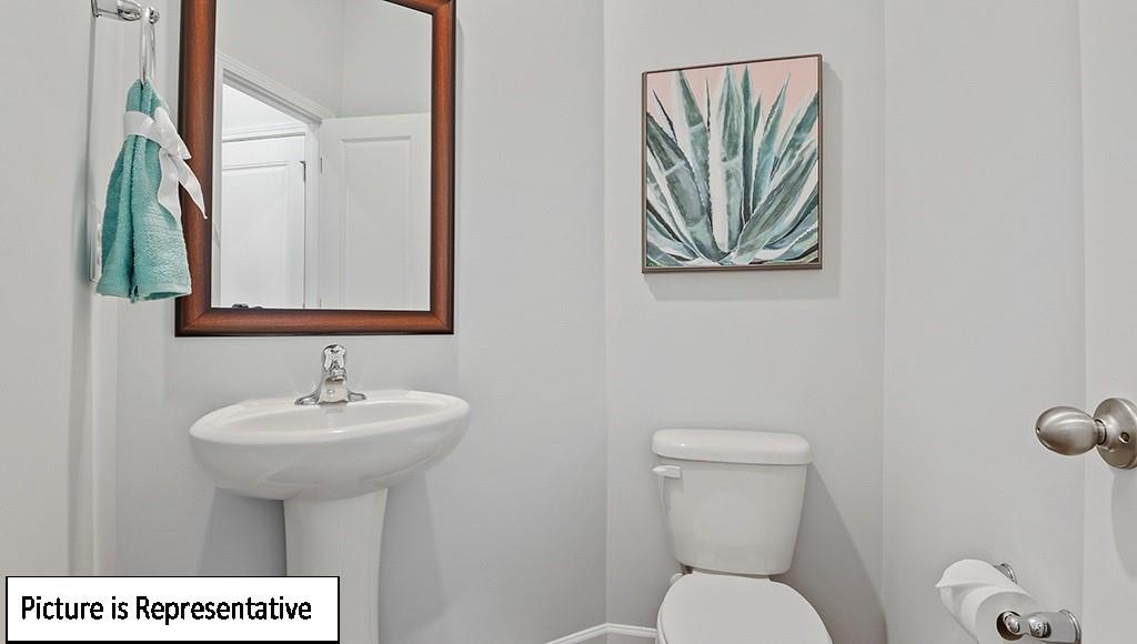 7012 North Mill Road Charlotte, NC 28216 - Photo 4 of 26 a bathroom with a toilet a sink and mirror