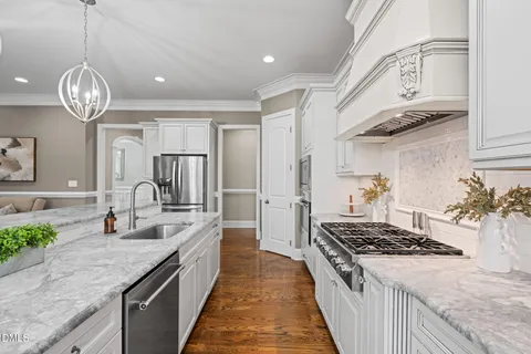 a kitchen with a table chairs and wooden floor