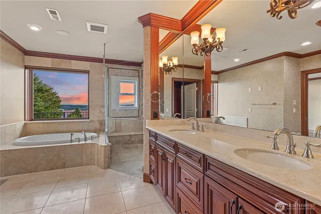 a spacious bathroom with a granite countertop sink a large mirror and a bathtub