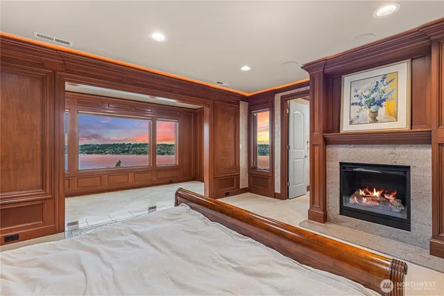 a living room with a fireplace and a large window