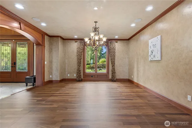 a view of a room with window and hardwood floor