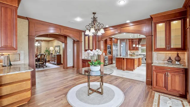 a living room with fireplace furniture and a chandelier