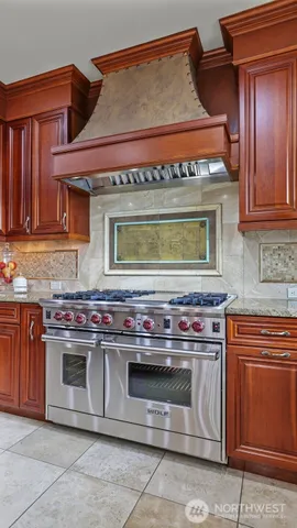 a stove top oven sitting inside of a kitchen