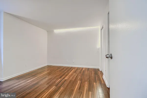 a view of a room with wooden floor