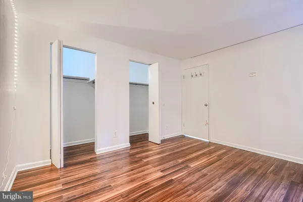 a view of a room with wooden floor