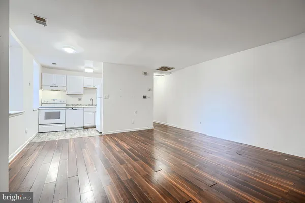 a view of a kitchen with wooden floor and a sink