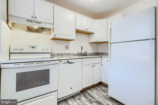a kitchen with stainless steel appliances granite countertop a sink and a stove