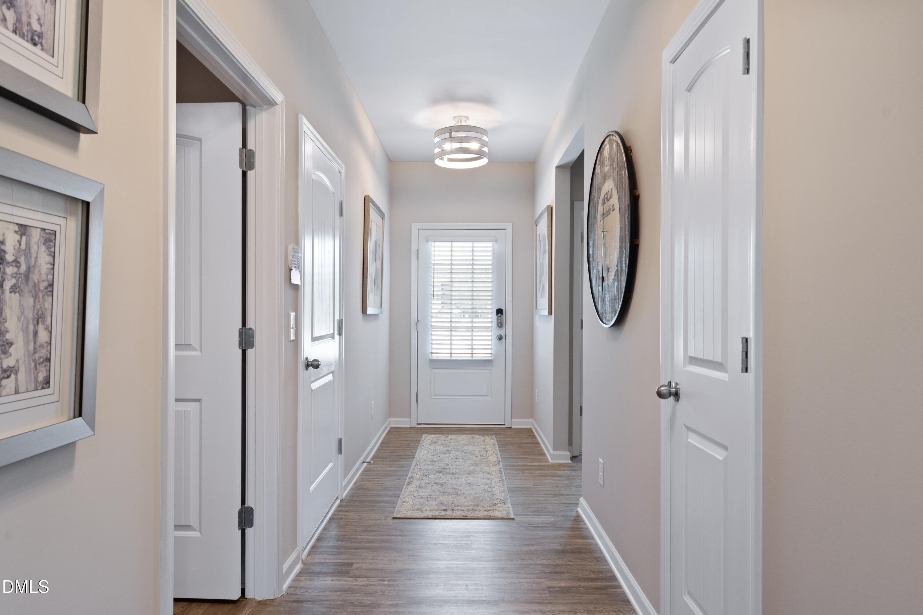 311 White Azalea Way Benson, NC 27504 - Photo 3 of 26 a view of a hallway with wooden floor