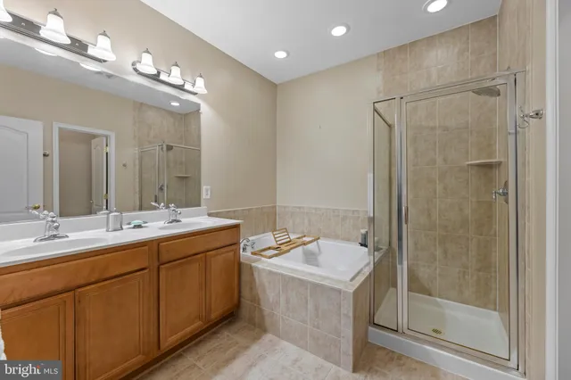 a bathroom with a double vanity sink mirror and shower