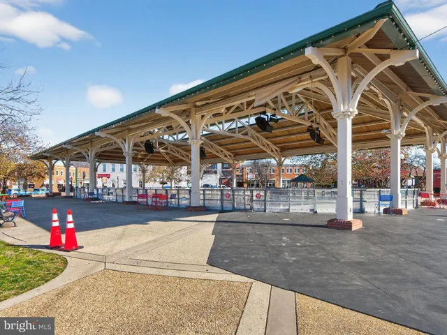 a view of a chairs and tables in the patio and a fountain in yard