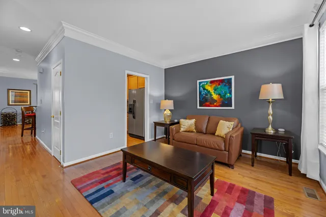 a living room with furniture and a painting on the wall