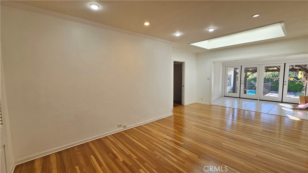 1525 Bellwood Road San Marino, CA 91108 - Photo 13 of 25 an empty room with wooden floor and windows
