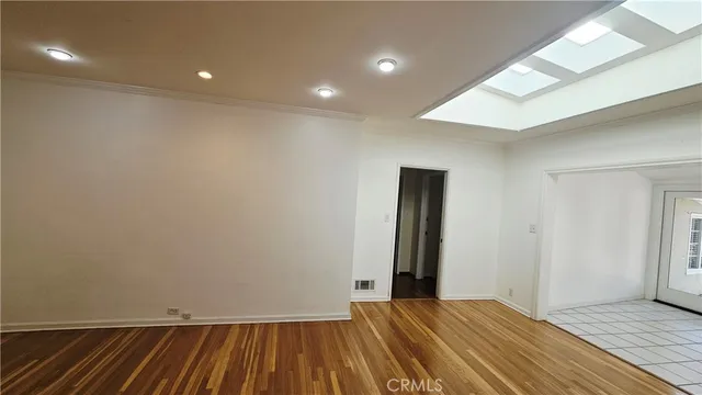 a view of a room with wooden floor and a sink