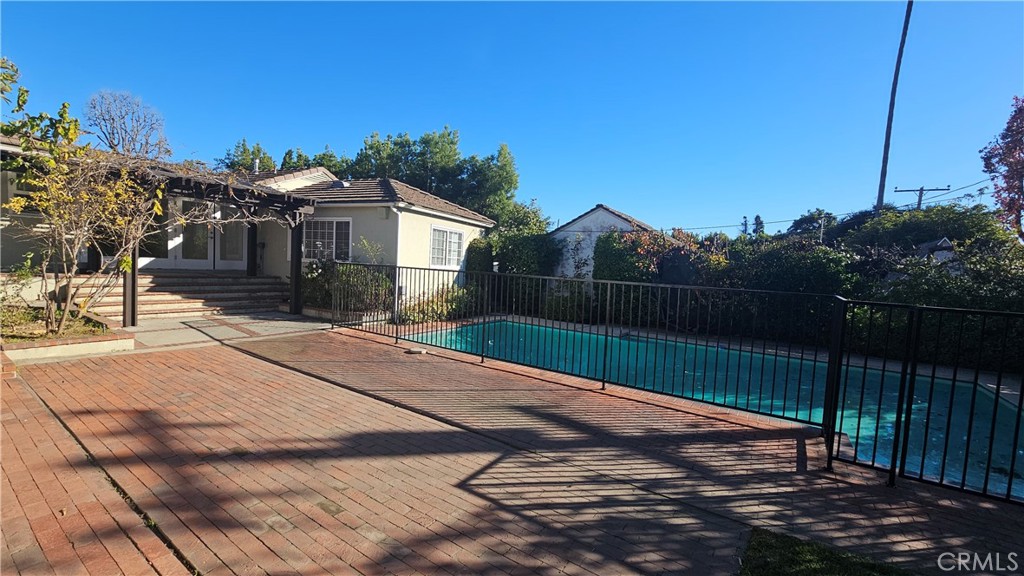 1525 Bellwood Road San Marino, CA 91108 - Photo 4 of 25 a view of a white house with a yard and wooden fence