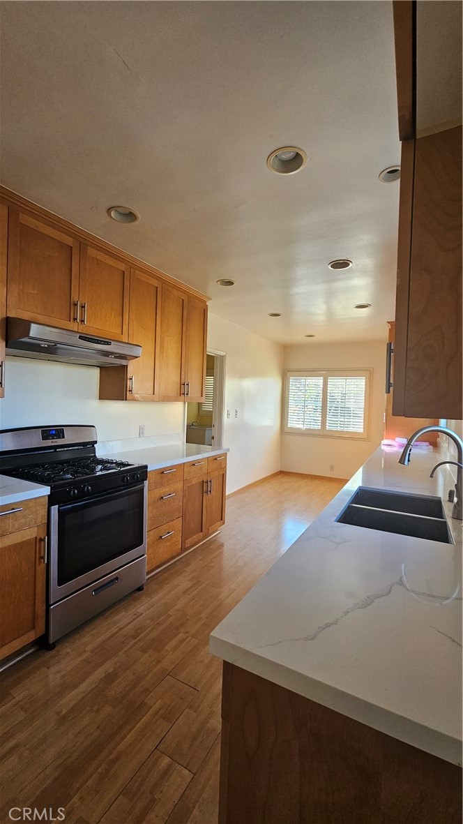 1525 Bellwood Road San Marino, CA 91108 - Photo 10 of 25 a kitchen with stainless steel appliances granite countertop a sink and a stove