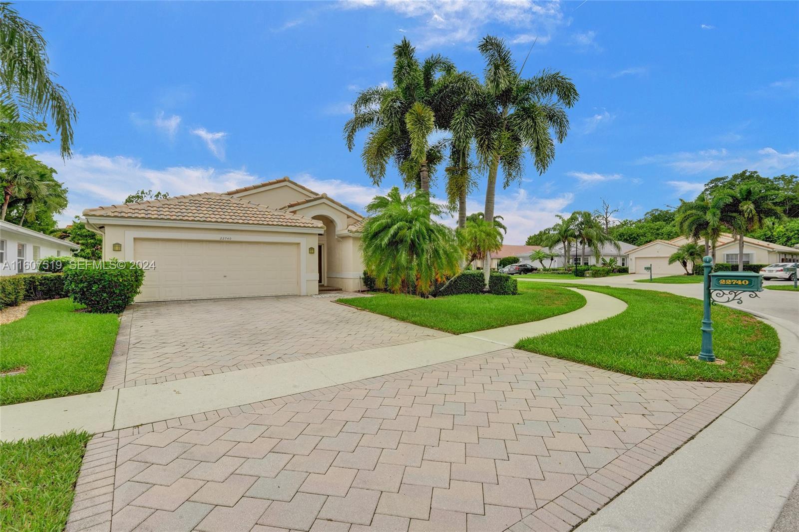 22740 Royal Crown Terrace East Boca Raton, FL 33433 - Photo 1 of 26 a front view of a house with a garden and yard
