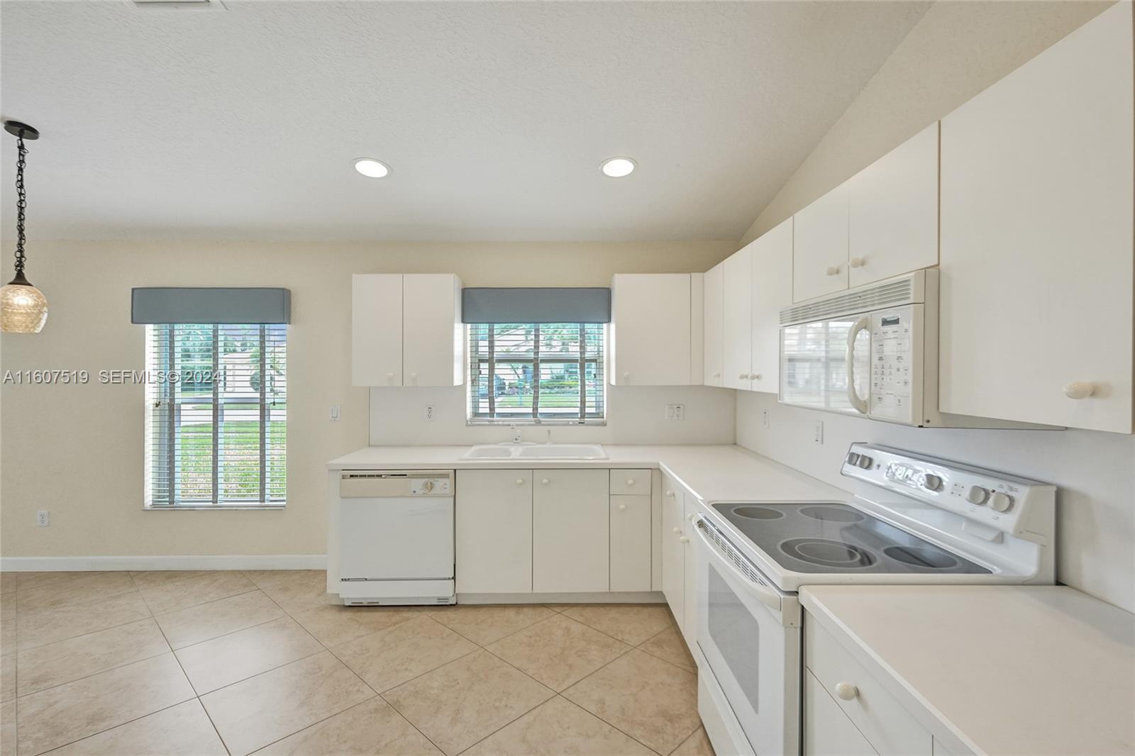 22740 Royal Crown Terrace East Boca Raton, FL 33433 - Photo 11 of 26 a kitchen with a stove a sink and a refrigerator