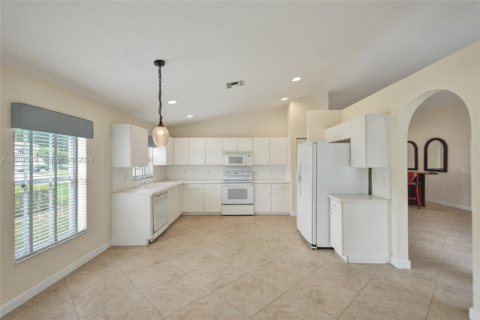 22740 Royal Crown Terrace East Boca Raton, FL 33433 - Photo 13 of 26 a view of a kitchen with white cabinets and a stove